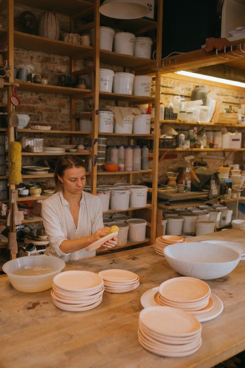 Free Skilled artisan shaping pottery in a well-equipped ceramic workshop. Stock Photo