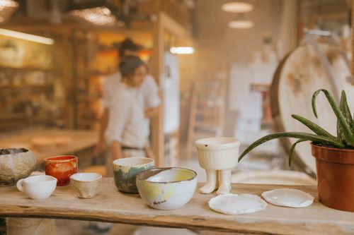 Free Handcrafted pottery displayed in a cozy ceramics workshop with artistic flair. Stock Photo