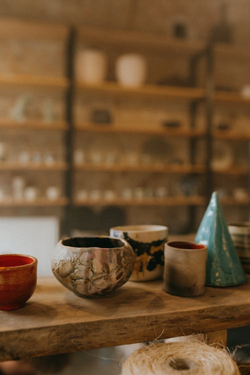 Ceramic Bowl and Cups on Wooden Surface 