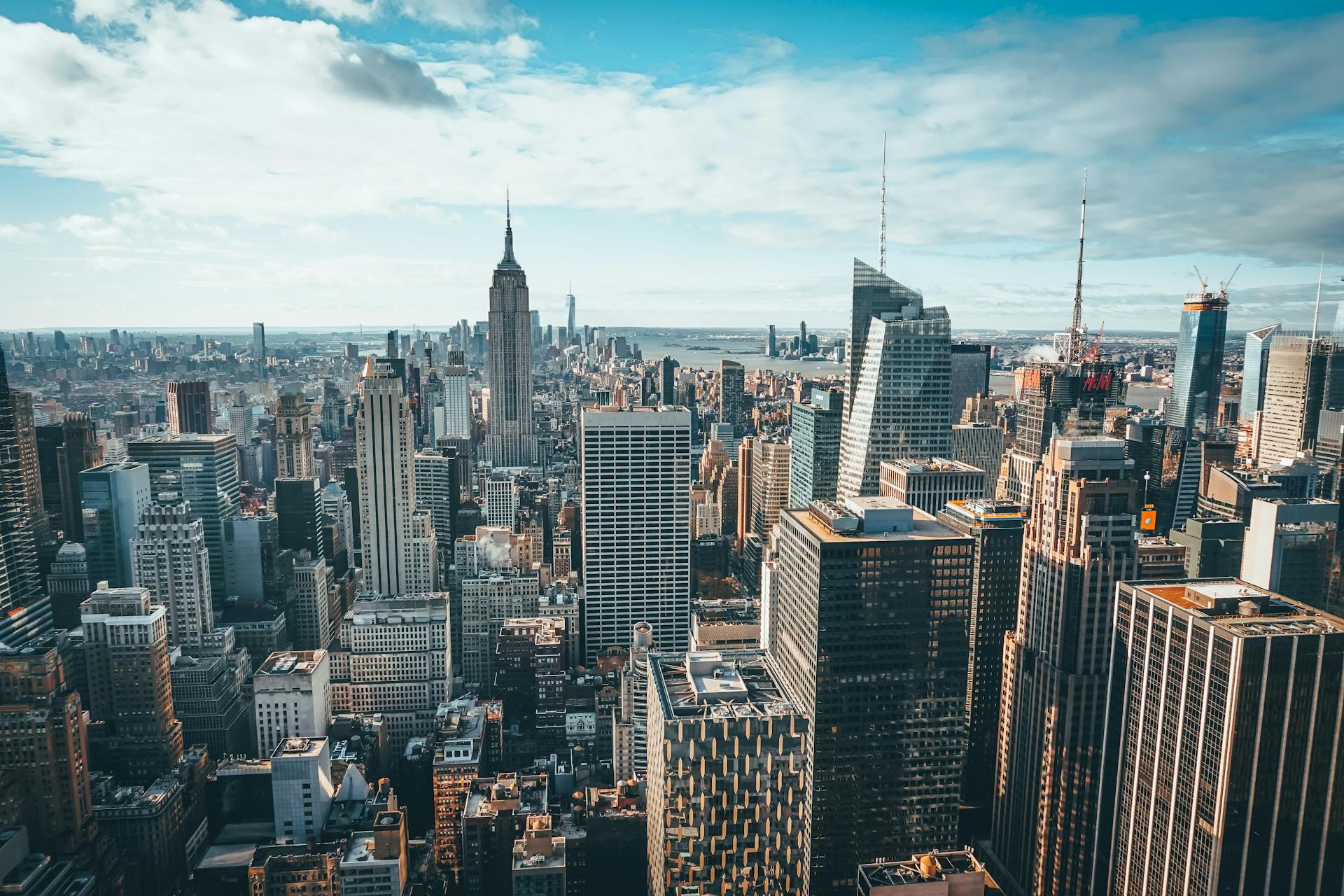 Stunning aerial view of New York City skyline featuring the iconic Empire State Building and skyscrapers.