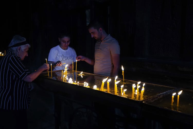 People Lighting Candles 