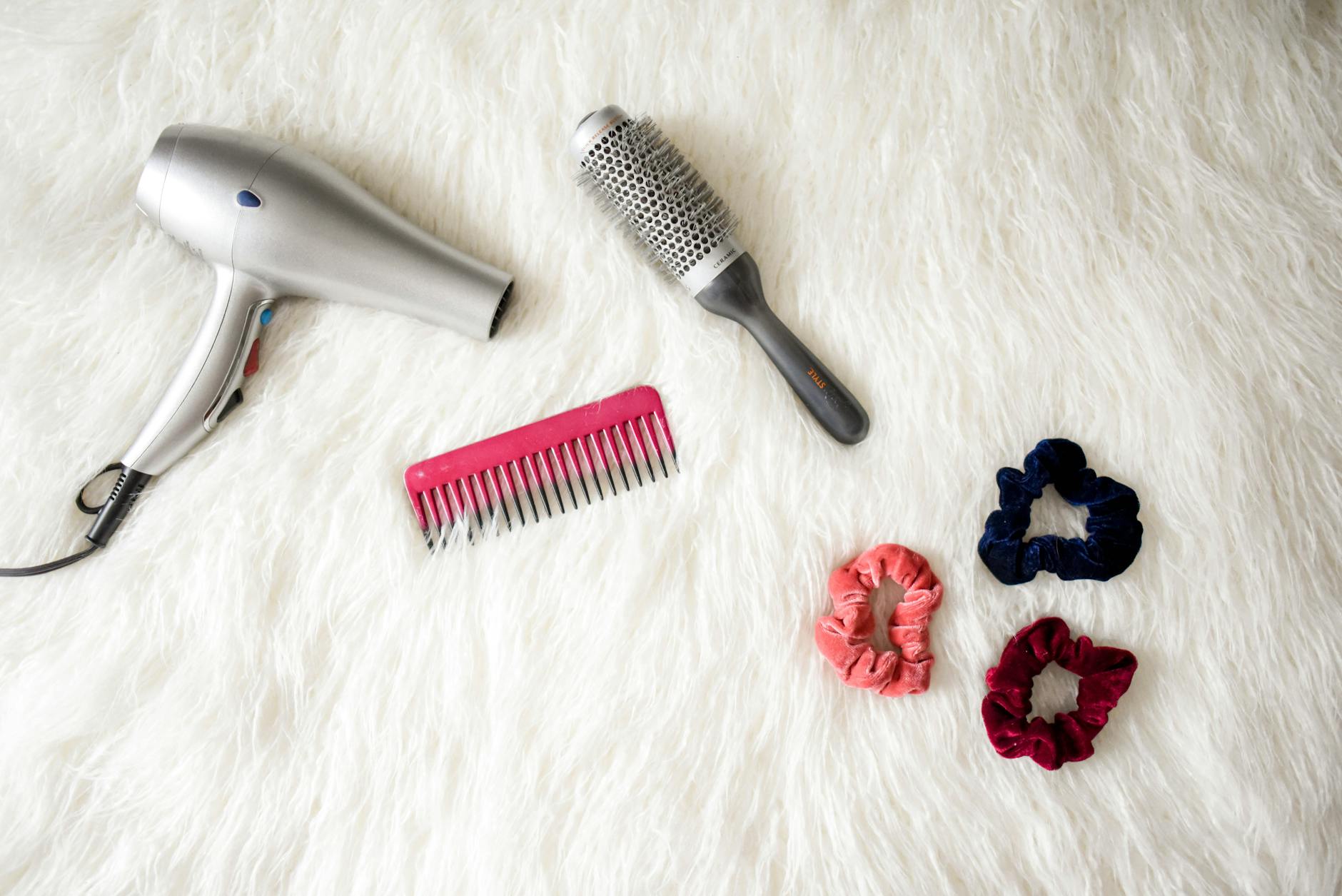 a hair dryer, comb and hair accessories