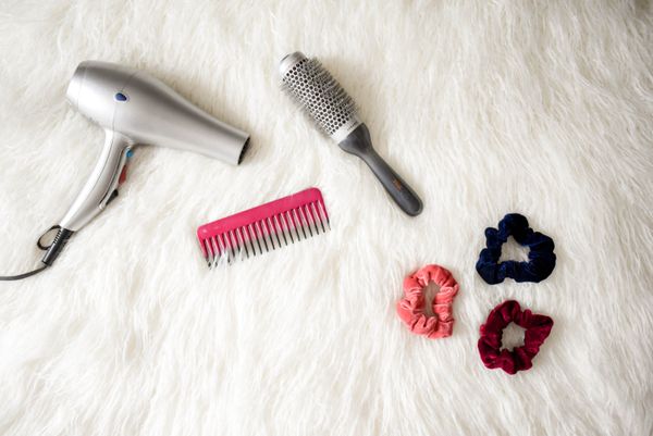 Professional hair dryer and styling combs in a salon setting