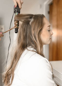 Woman Holding Gray Hair Dryer and Wearing White Bathrobe 