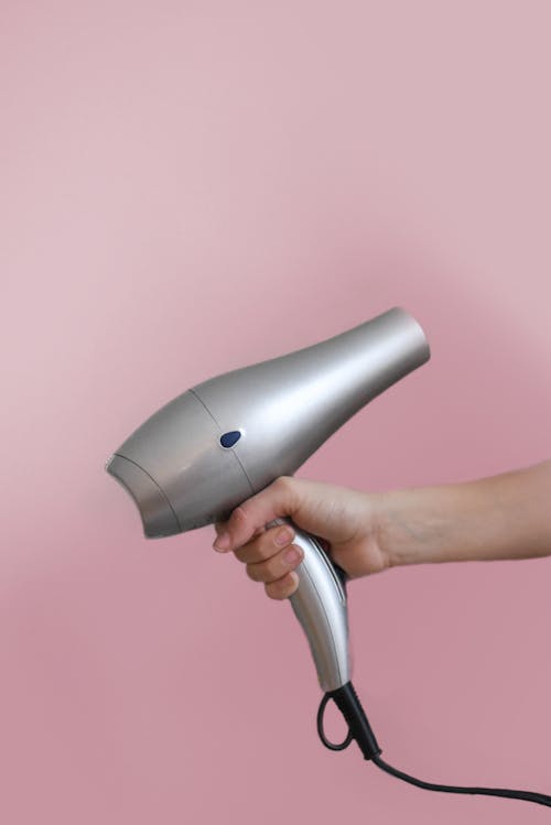 Free Person Holding Grey Hair Dryer Stock Photo