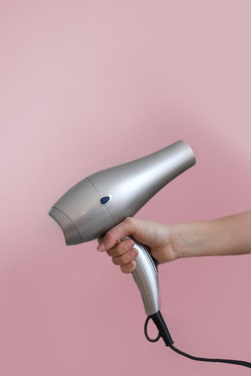 Person Holding Grey Hair Dryer