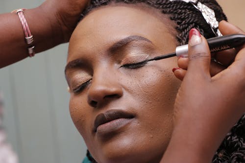 Woman Applying Mascara on Eyelid