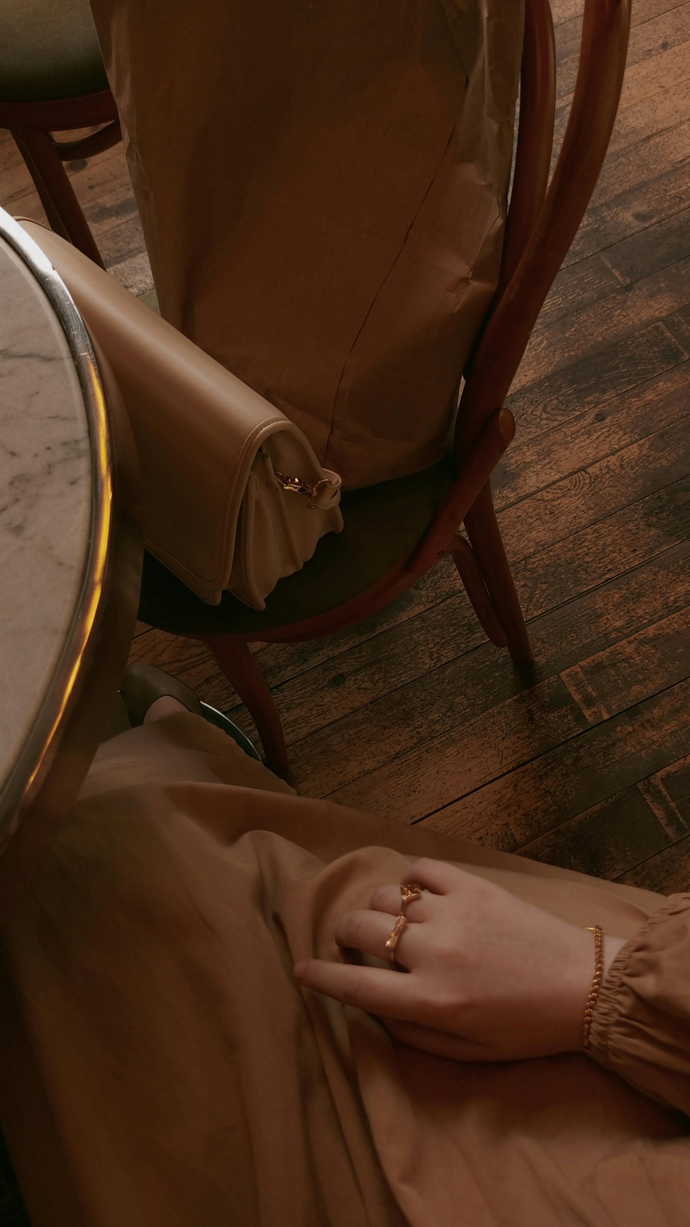 Top view of a woman with a ring holding her handbag