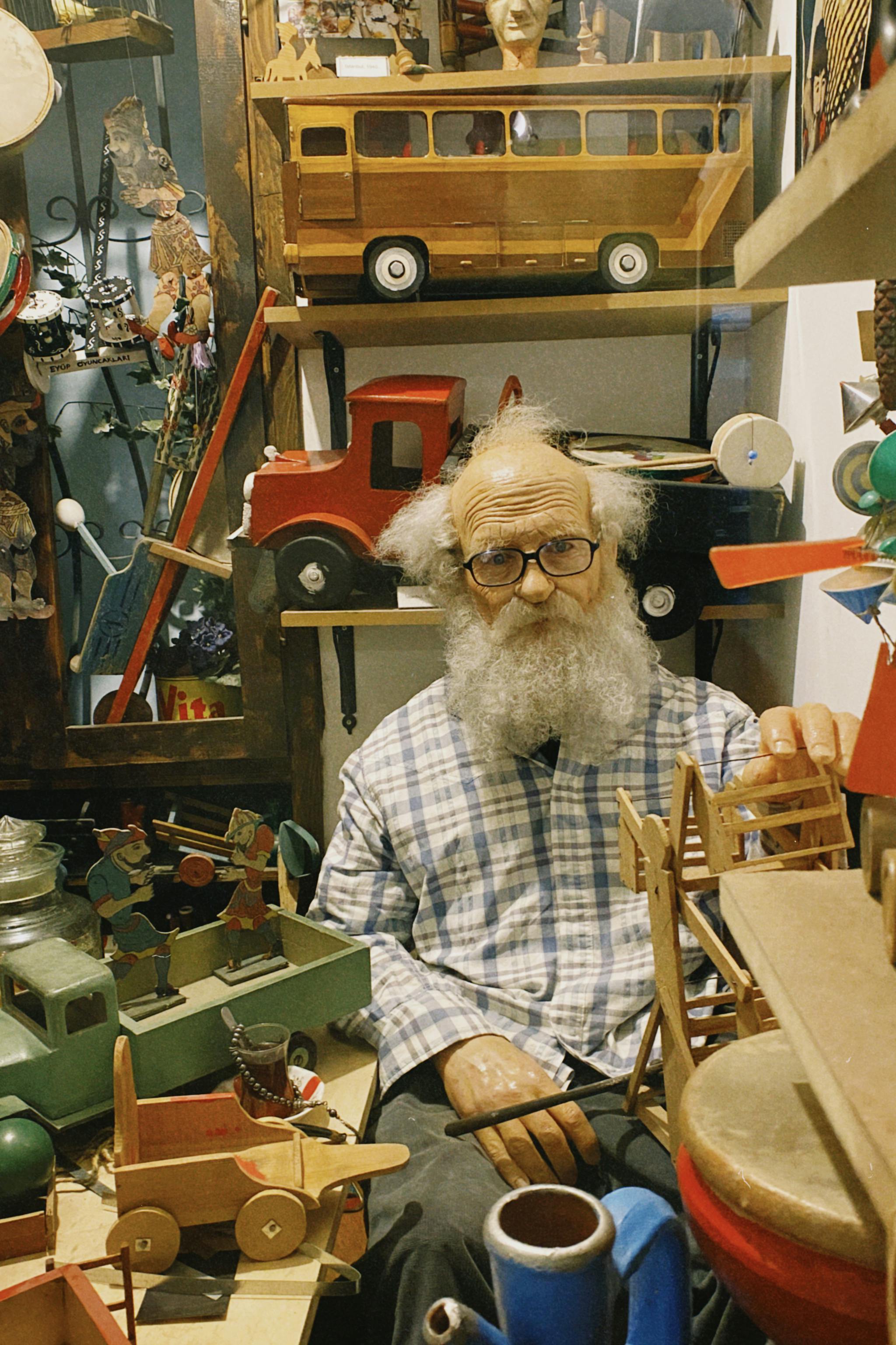 senior adult mannequin beside wooden toys