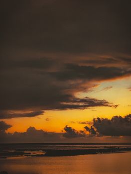 A breathtaking ocean view at sunset with dramatic cloud formations and golden hues.