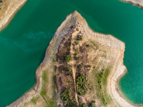Free Stunning aerial view of a narrow peninsula with vibrant turquoise waters showcasing natural beauty. Stock Photo