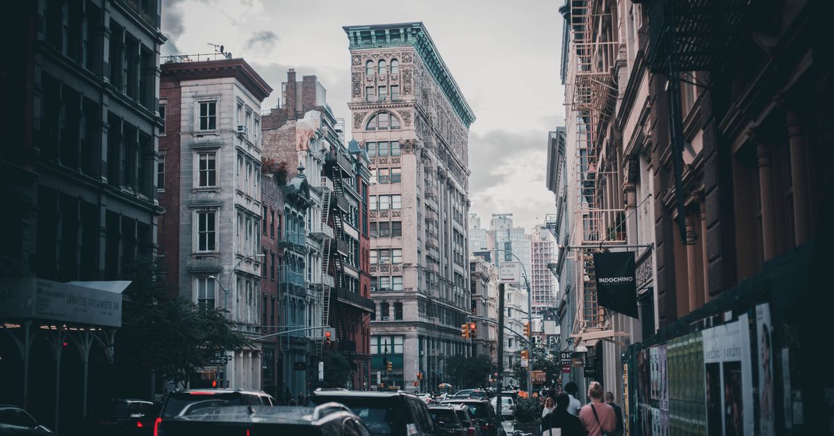 Urban scene capturing traffic and pedestrians in historic Soho, NYC.