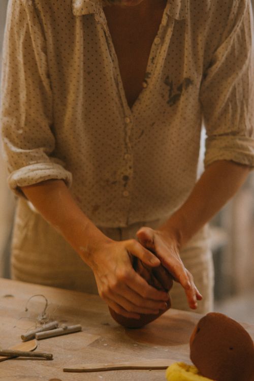 Free Close-up of hands molding clay in a pottery workshop, capturing the artisanal craft process. Stock Photo