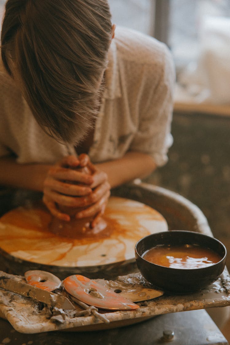 Woman Shaping A Clay