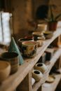 White Blue and Red Ceramic Mugs on White Wooden Shelf