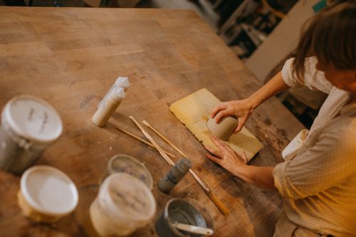 Free An artisan handcrafting ceramics in a creative workshop environment, focusing on skill and craftsmanship. Stock Photo