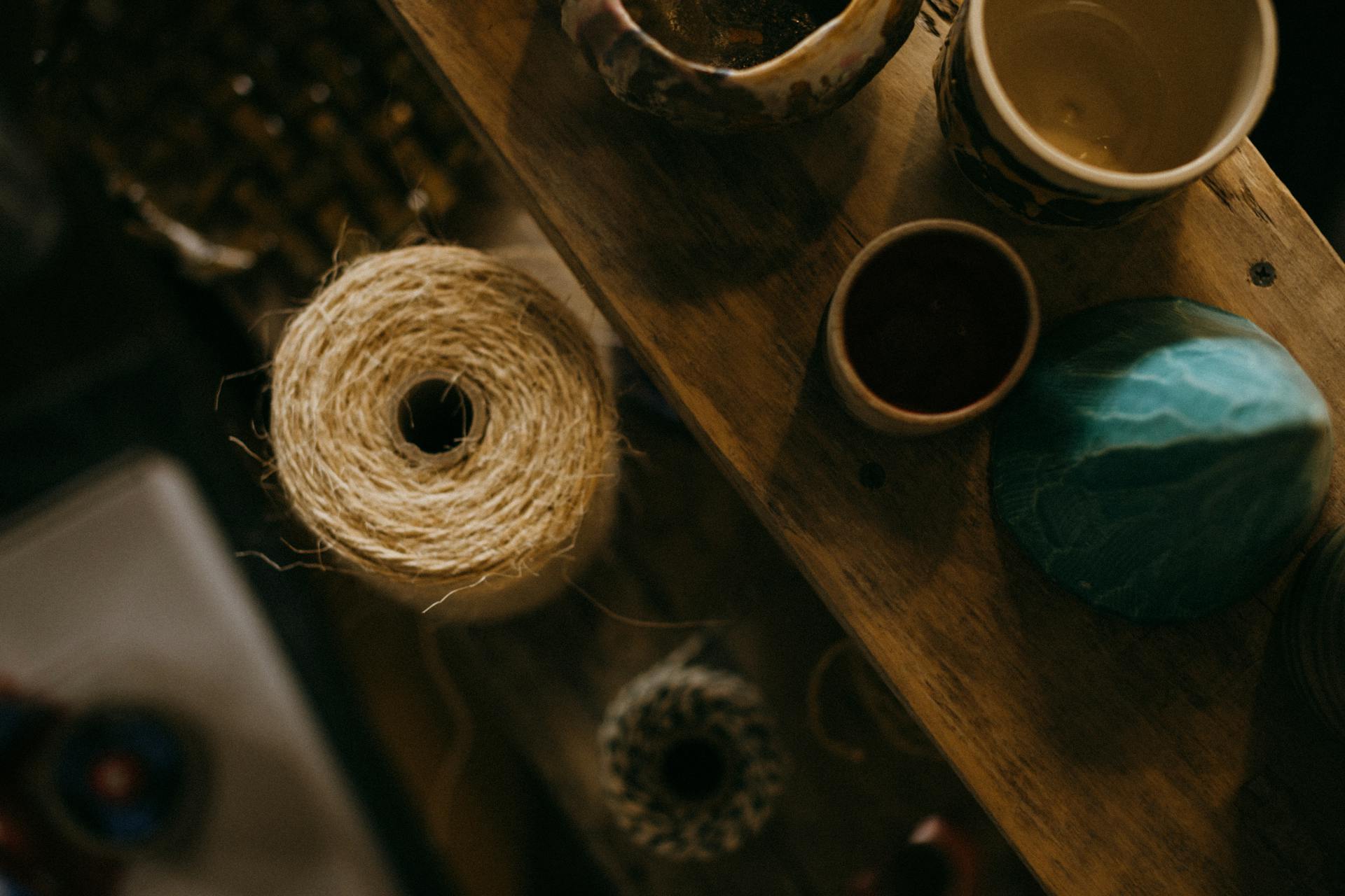Overhead Roll of Thread beside Cups