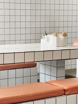 Stylish interior featuring a tiled dining table with vibrant seating.