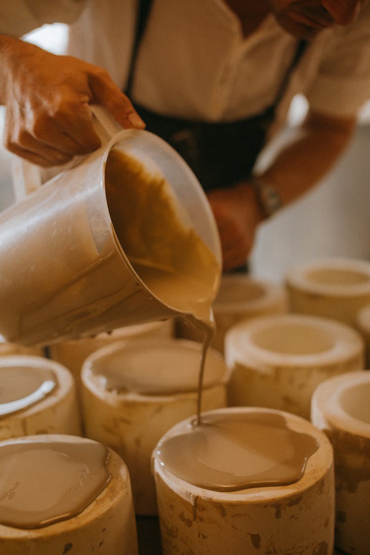 Pouring Of Clay Substance On Molds 