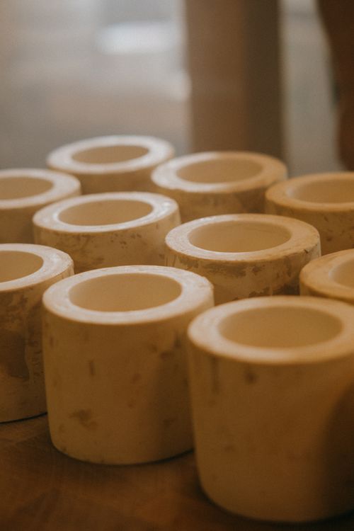 Free Close-up of handmade clay molds arranged in a rustic, warm setting. Stock Photo