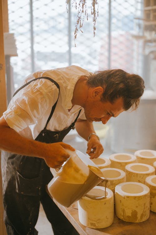 Skillful Man pouring Liquid Pottery on a Mold 