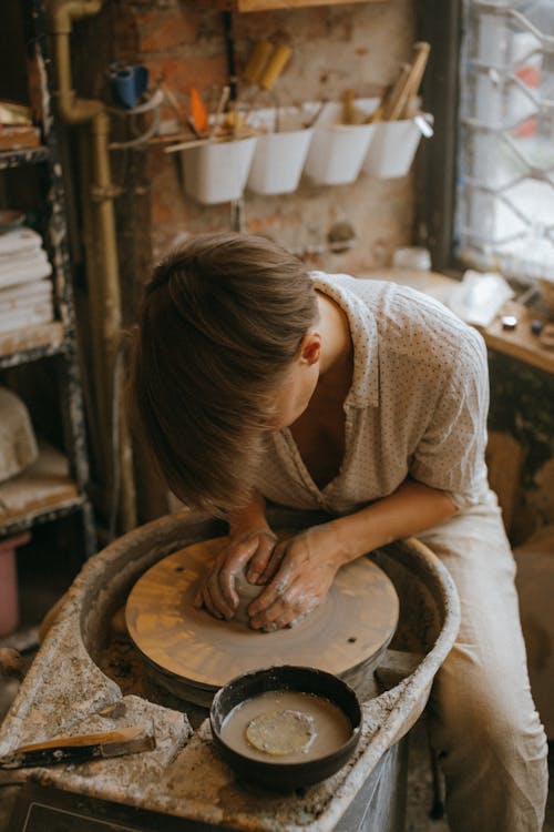 Craftsman molding a Clay Pot