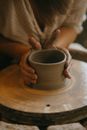 Person Making Clay Pot on Brown Wooden Table