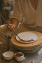 Person Holding Silver Spoon on White Ceramic Bowl