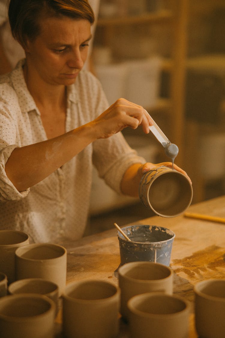 Craftsman Doing Finishing Touches At His Clay Pots