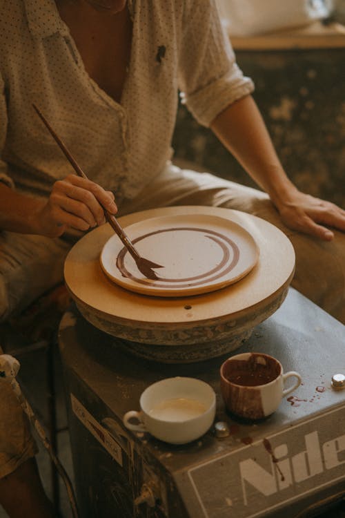 Craftsman doing Finishing Touches at Earthenware Plates