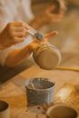 Person Holding White Egg on Brown Wooden Table