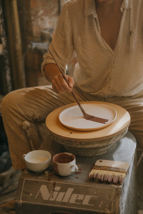 Craftsman doing Finishing Touches at Earthenware Plates