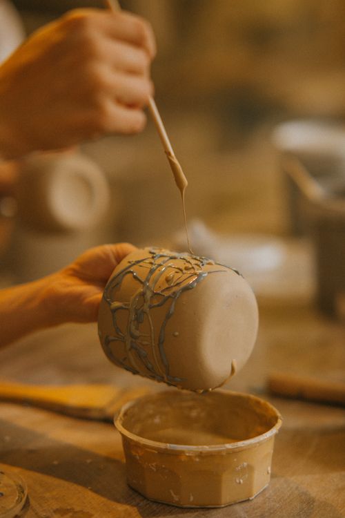 Free Close-up of crafting a clay mug with precise detail in an artisan workshop. Stock Photo