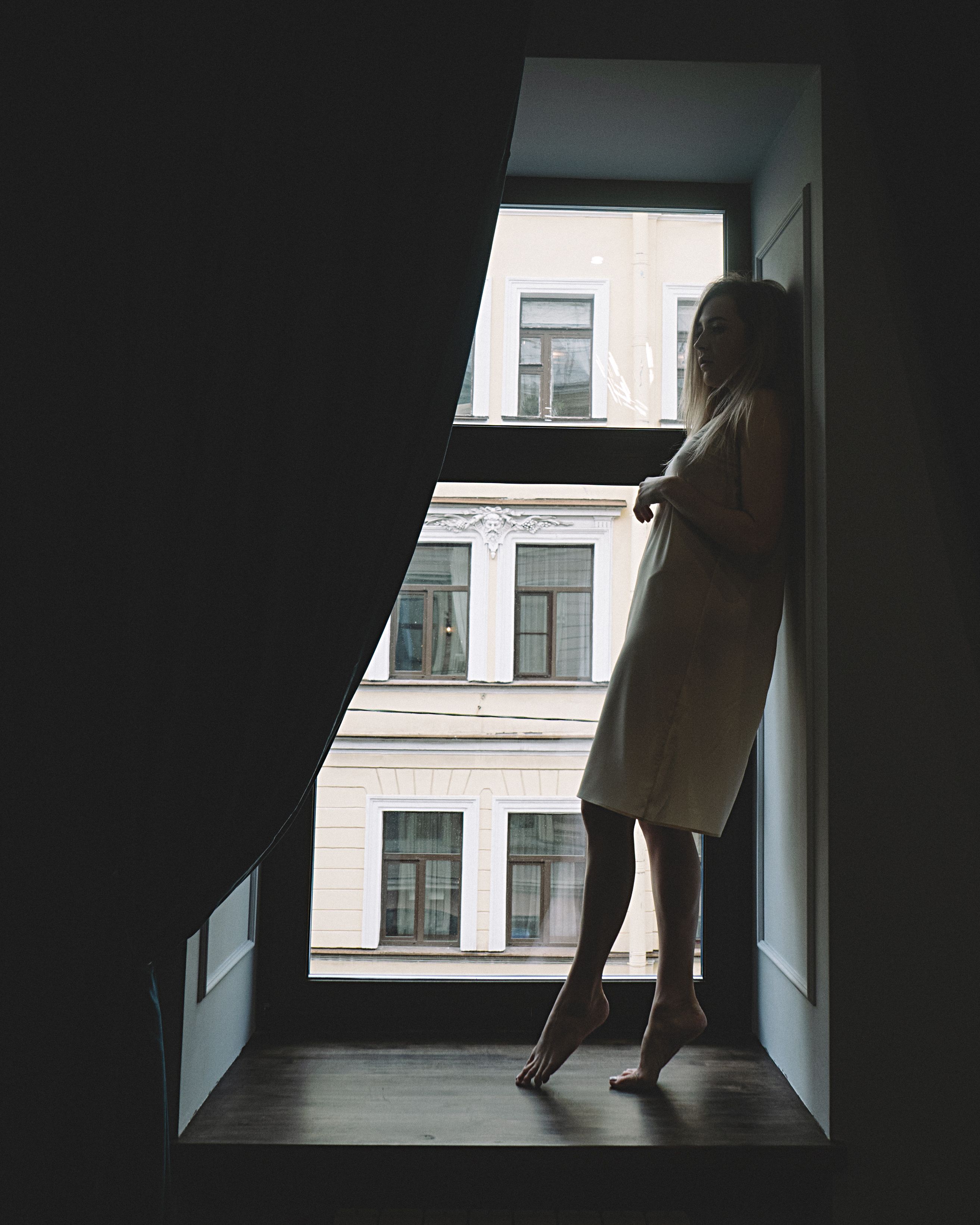 A Woman Standing Near Window · Free Stock Photo