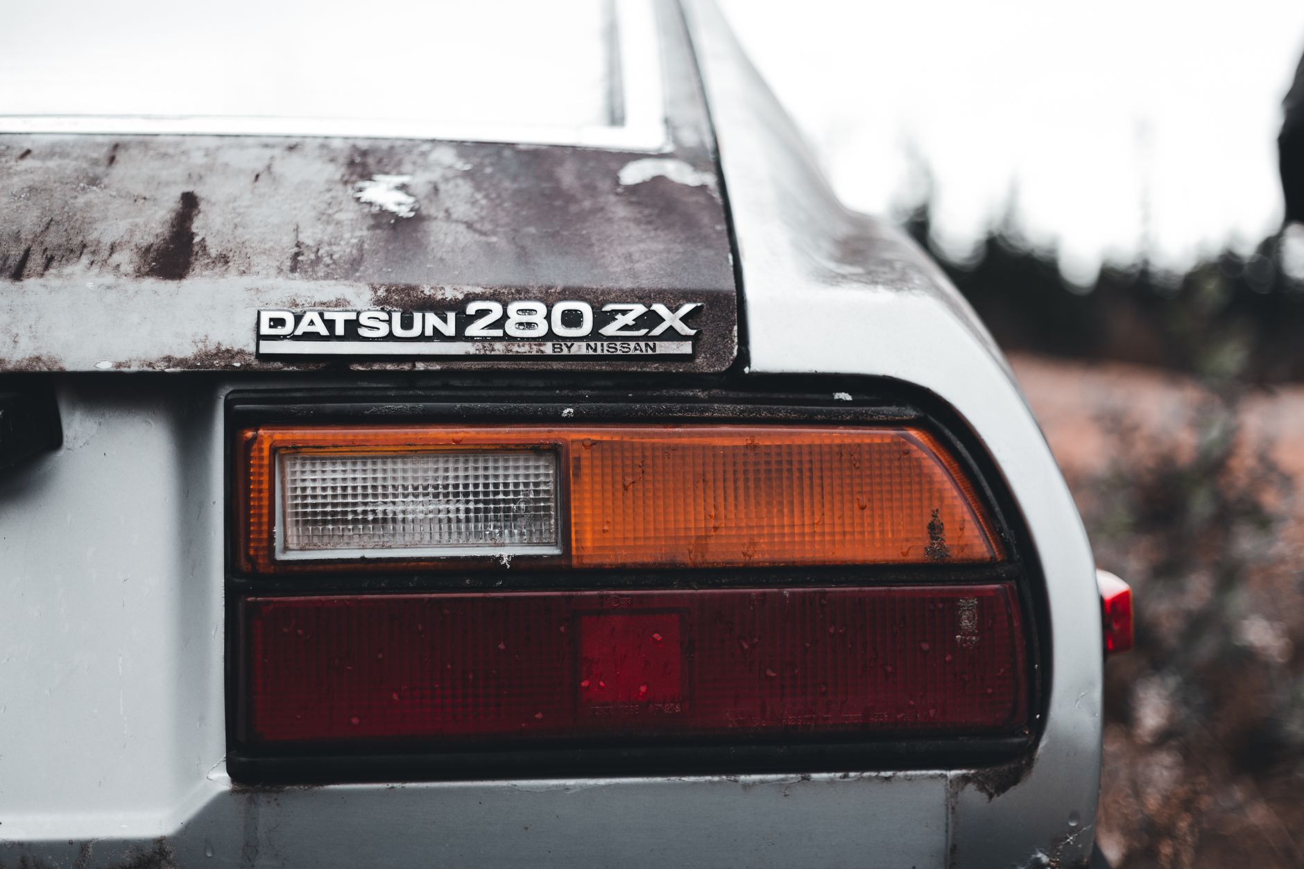 Close-up of a vintage Datsun 280ZX tail light showcasing its classic automotive style.