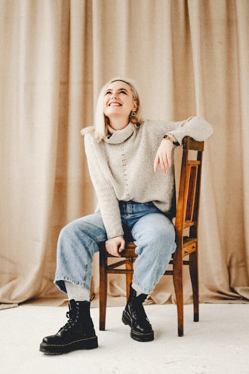 Young hair sitting on chair and smiling