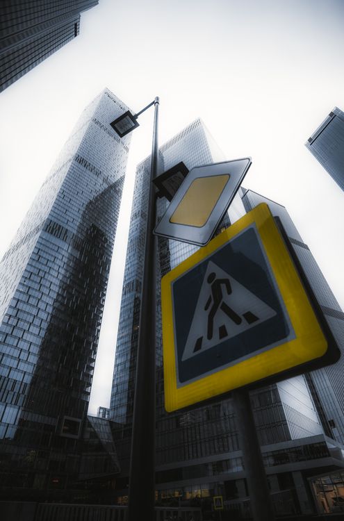 Low Angle Photography of Street Sign Post near High-rise Buildings ...