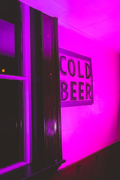 Signage on the Wall with a Hot Pink Light Setting 