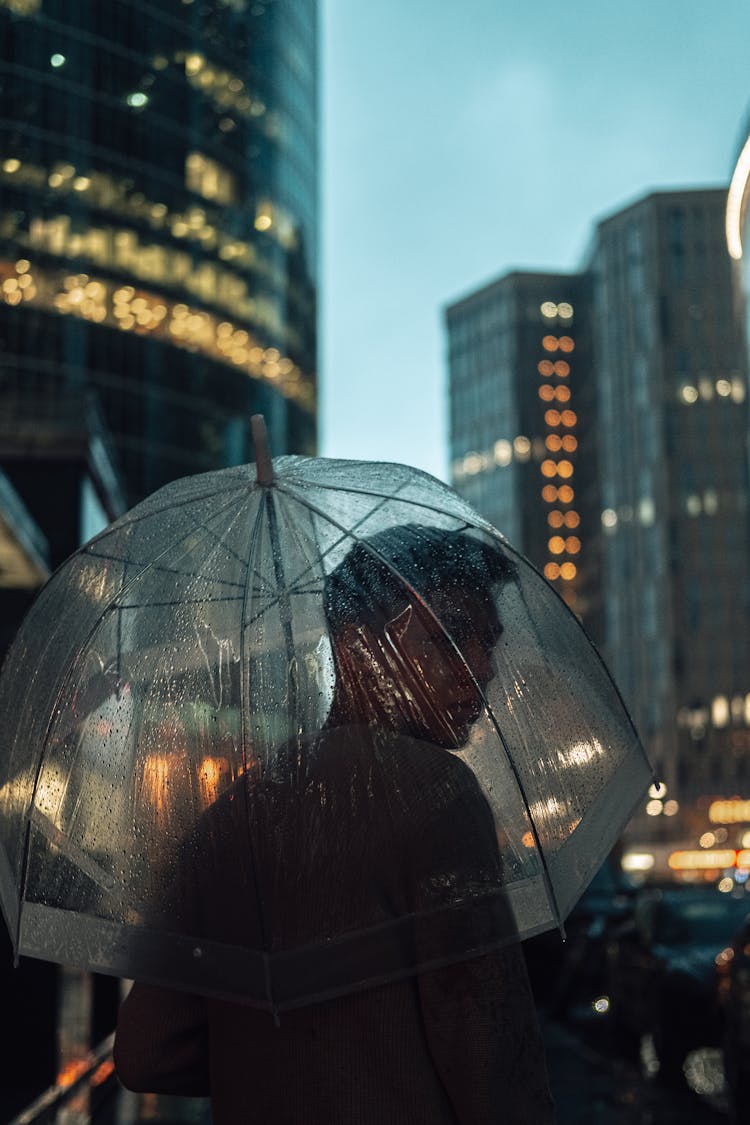 Man With Umbrella On Night City Street