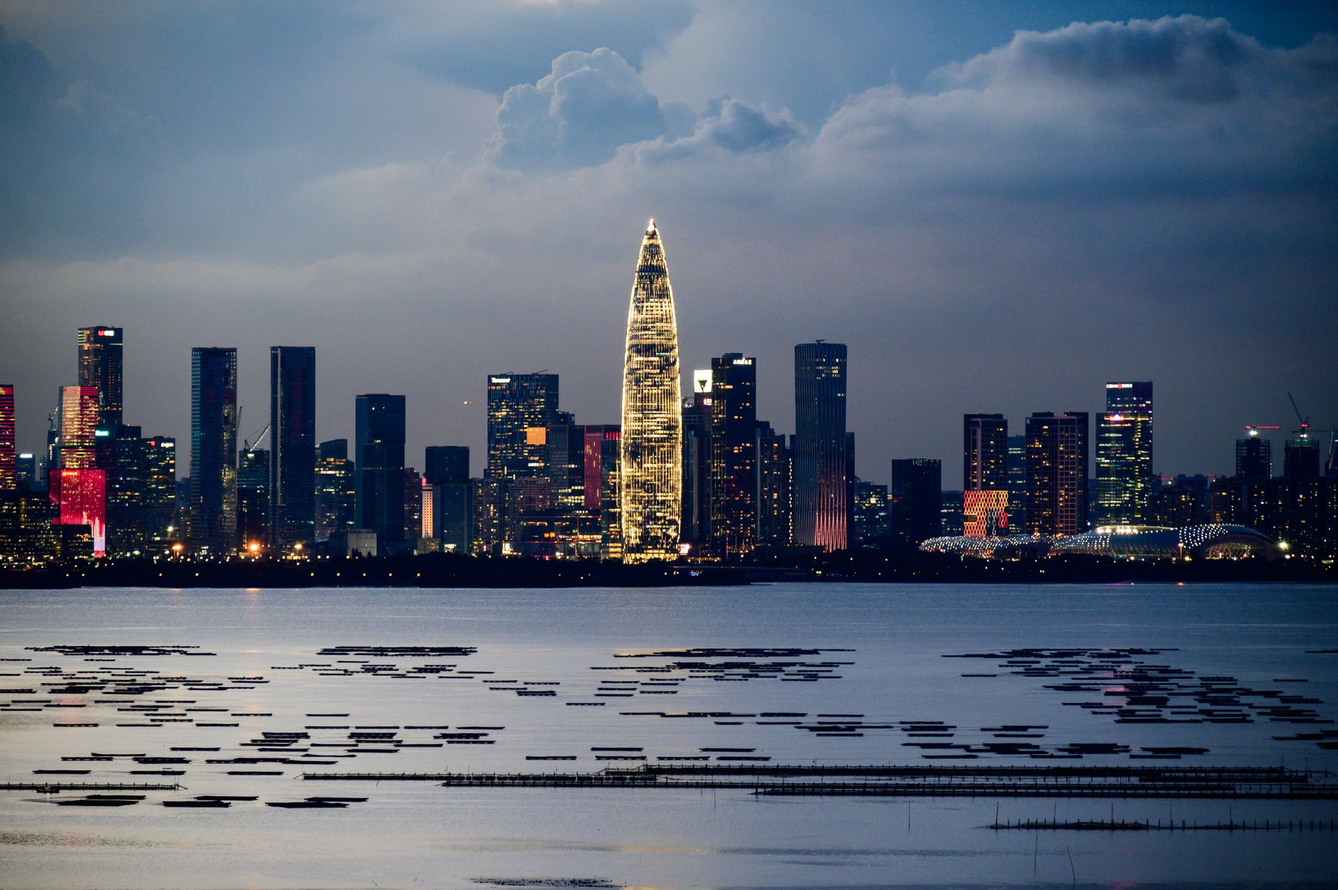A minimalist high-end executive office overlooking a global city skyline at dusk, symbolizing strategic legacy and transition.