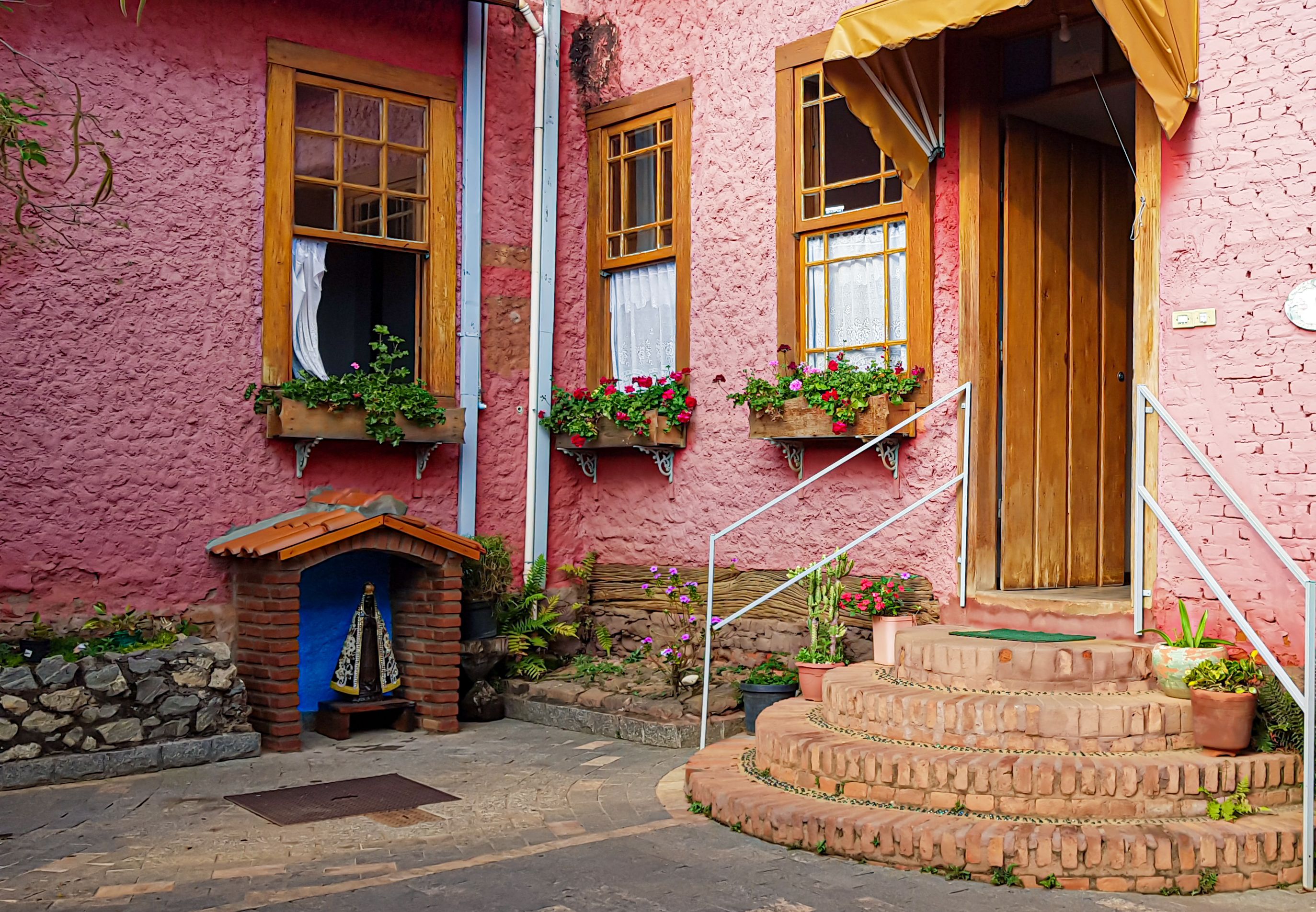 Alpine-style wooden facades and flower boxes on the main street of Treze Tilias