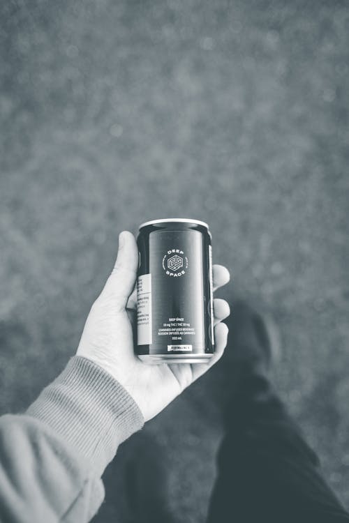 
A Person Holding a Canned Beverage