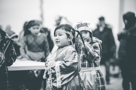 Children wearing traditional outfits at a cultural gathering, showcasing heritage.