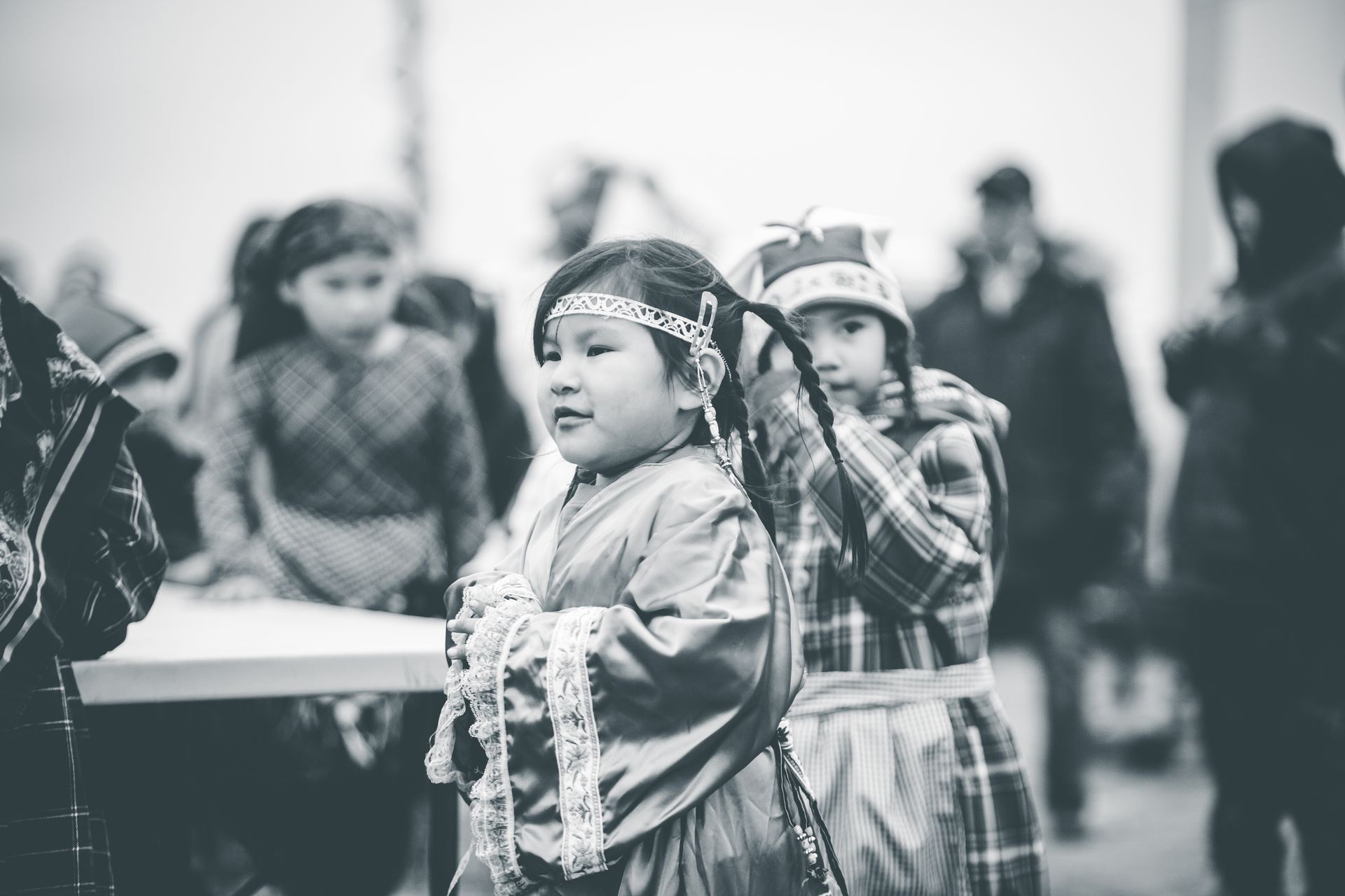 Children wearing traditional outfits at a cultural gathering, showcasing heritage.