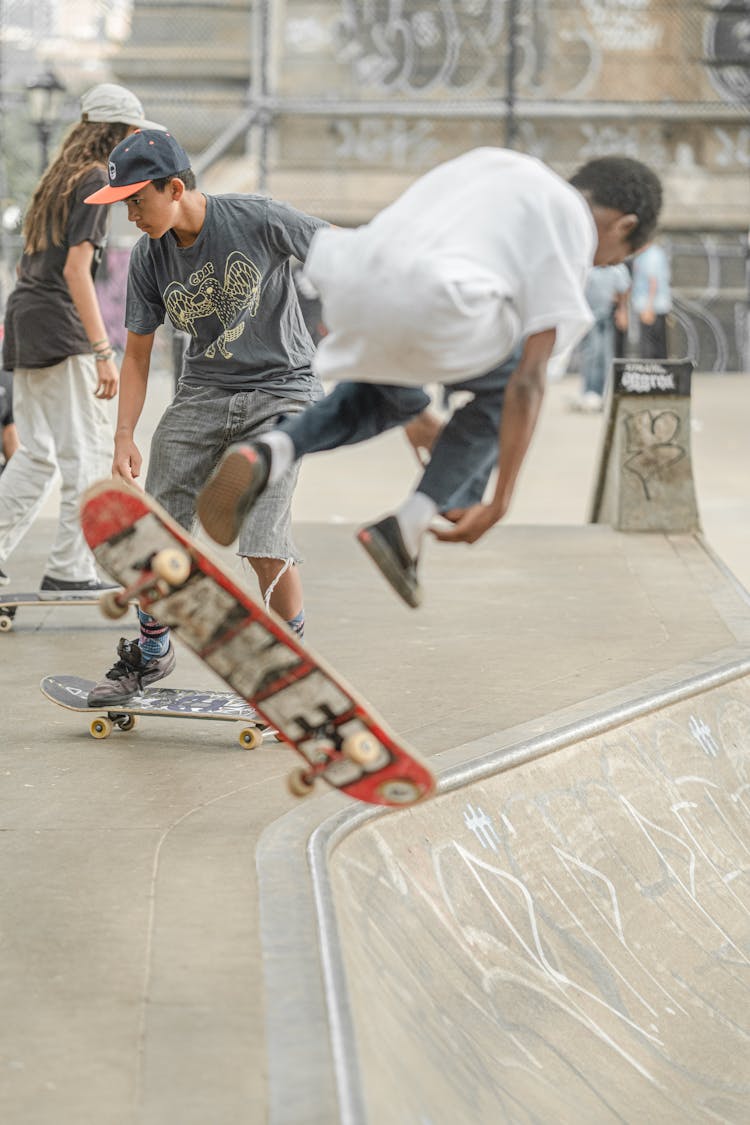 Young People Riding Skateboard On A Park