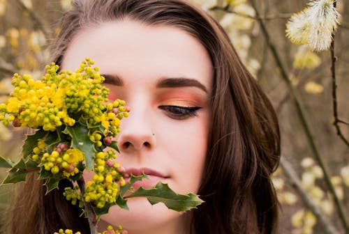 Woman Looking at a Green and Yellow Leafed Plant