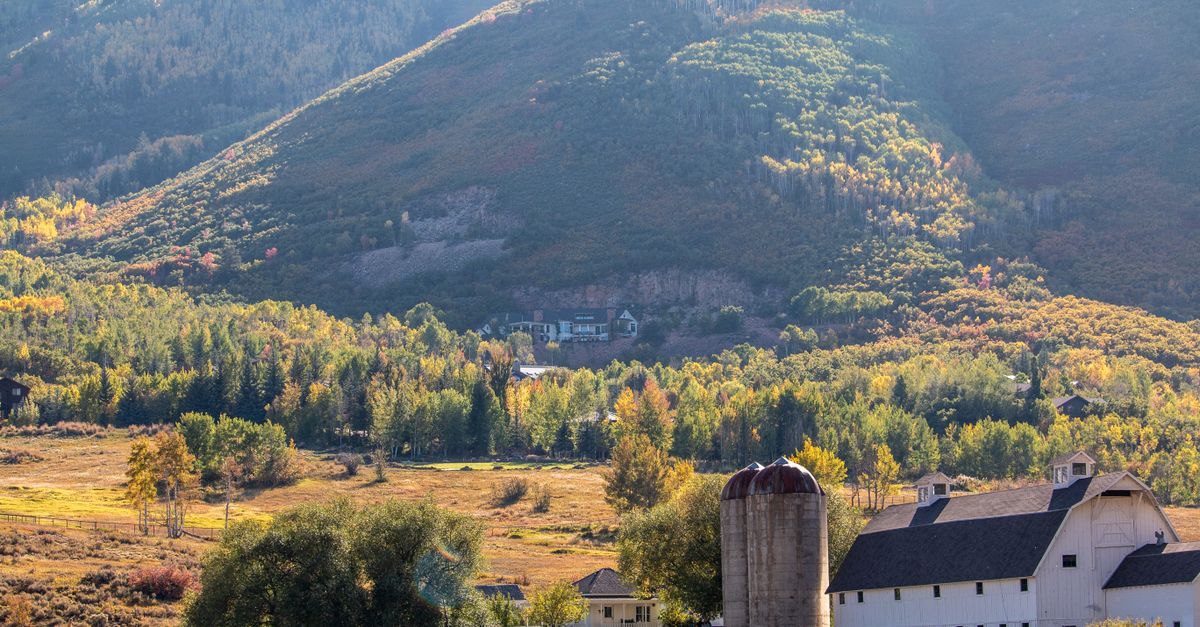 Scenic view of McPolin Barn amidst fall foliage in Park City, Utah.