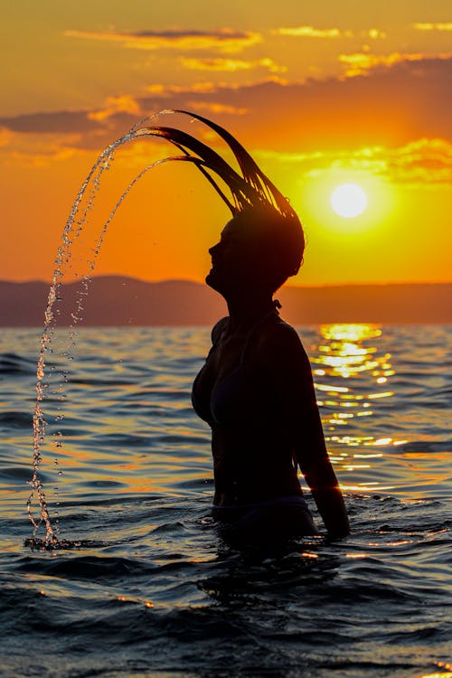 Silhouette of a Woman on Body of Water
