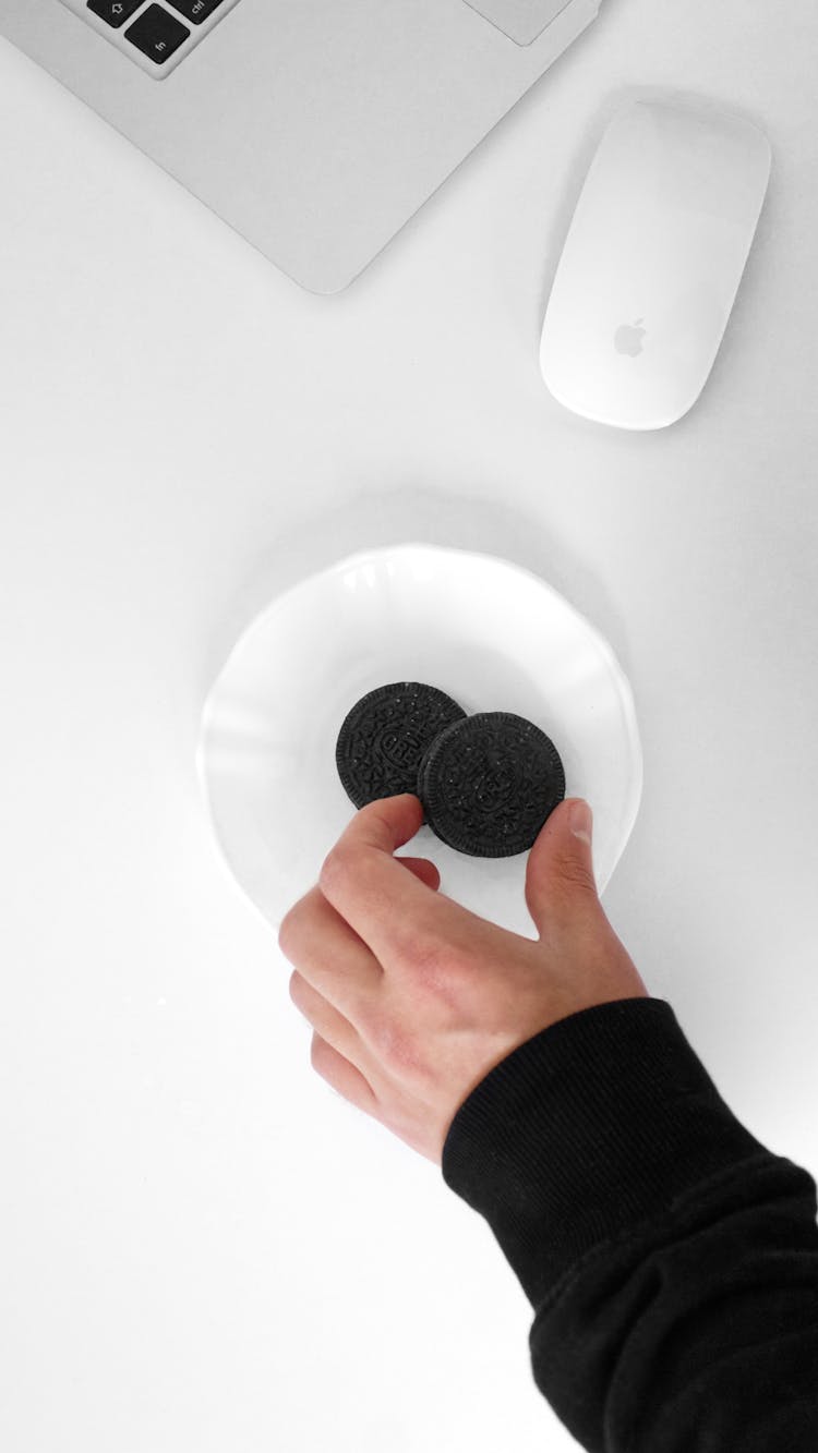 A Person Taking An Oreo Cookie