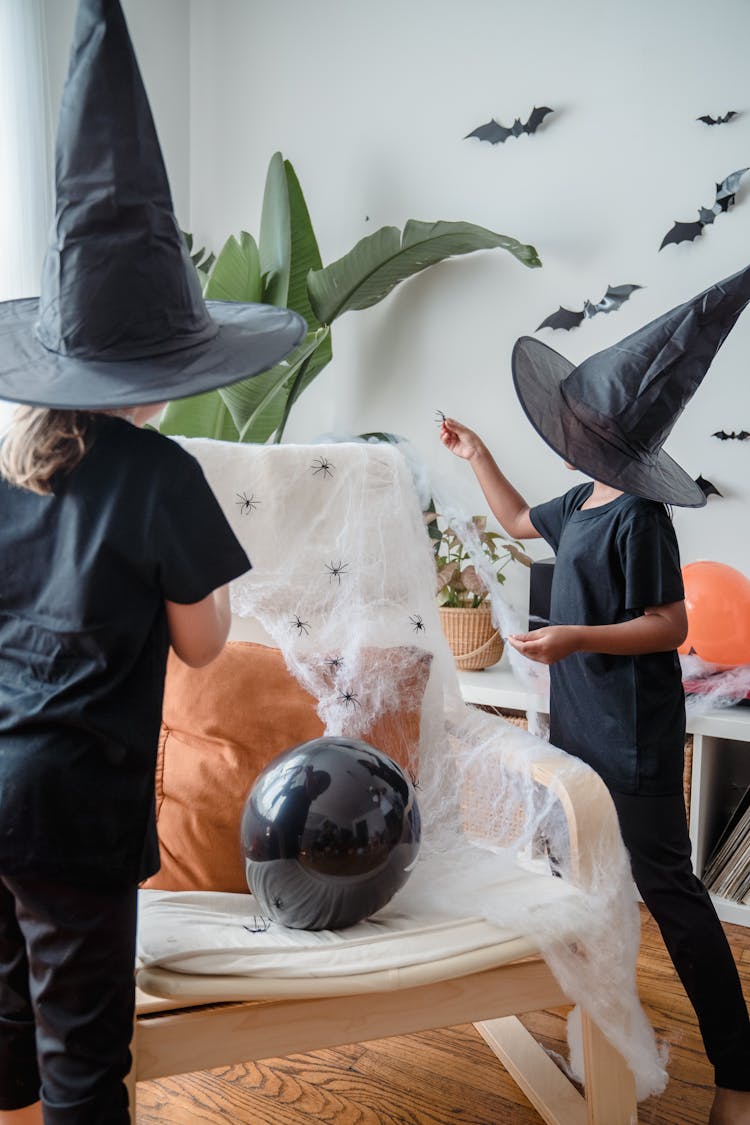 Young Girls In Witch Costumes Looking At Something